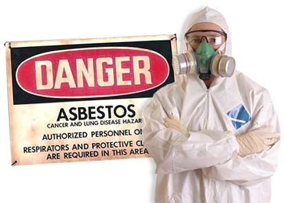 Asbestos Worker in full gear stands infront of warning sign that says Danger Asbestos